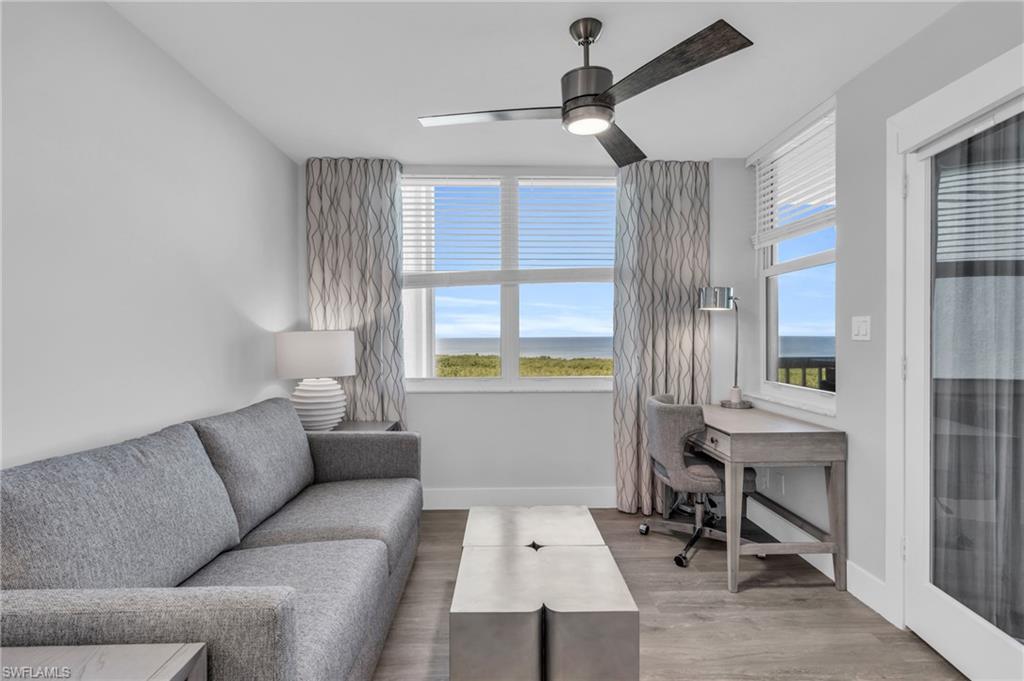 6573 Marissa Loop, Unit 1403 Naples, FL 34108 - Photo 13 of 29 a living room with furniture and a window