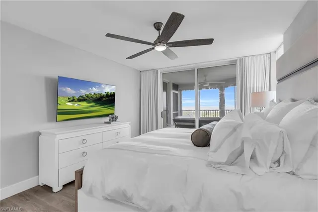 a bedroom with a bed and large window