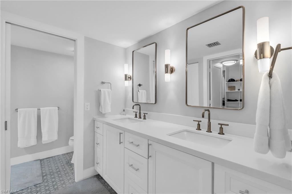 6573 Marissa Loop, Unit 1403 Naples, FL 34108 - Photo 16 of 29 a bathroom with a double vanity sink mirror and
