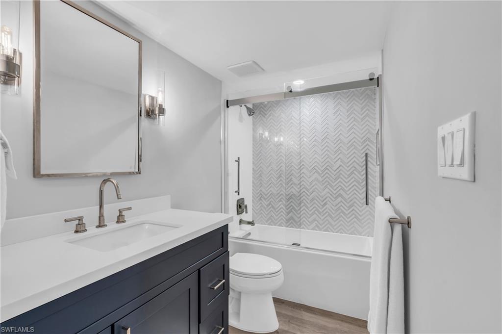 6573 Marissa Loop, Unit 1403 Naples, FL 34108 - Photo 20 of 29 a bathroom with a sink a toilet and shower