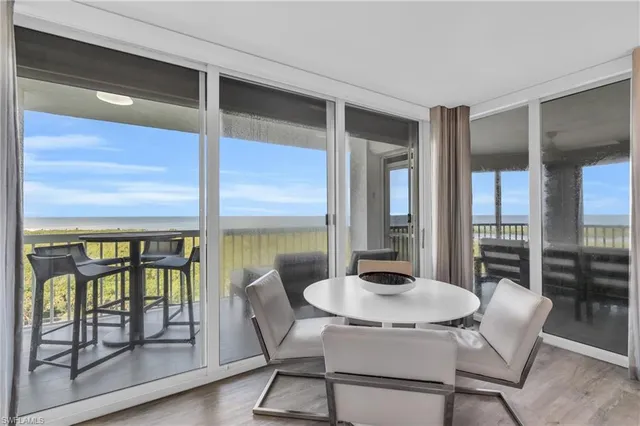 a view of a dining room with furniture window and wooden floor