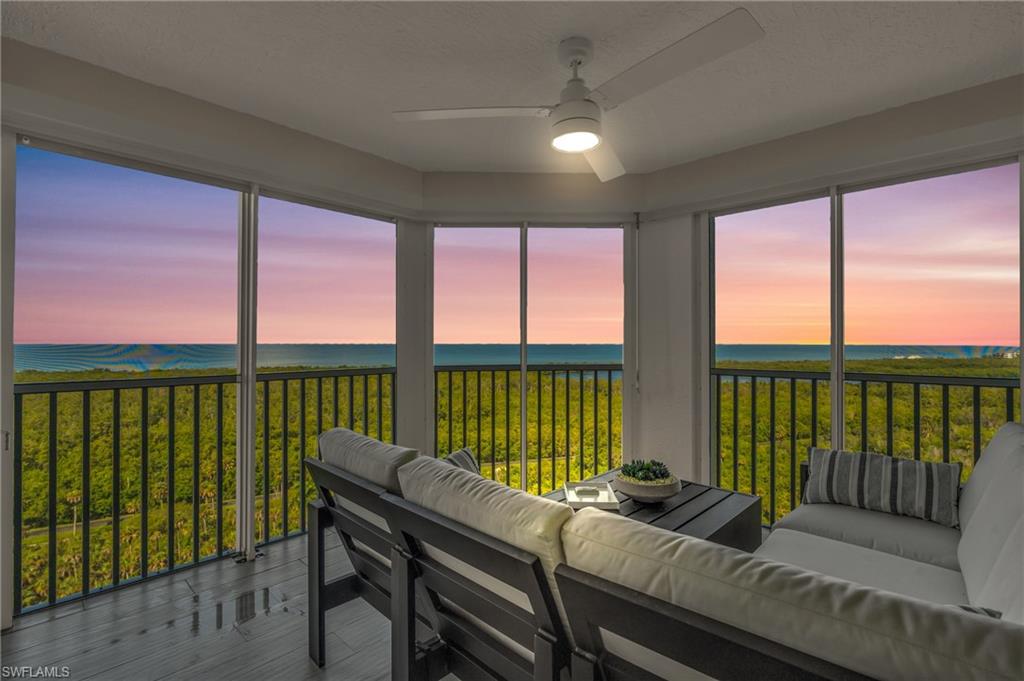6573 Marissa Loop, Unit 1403 Naples, FL 34108 - Photo 22 of 29 a living room with furniture and a floor to ceiling window