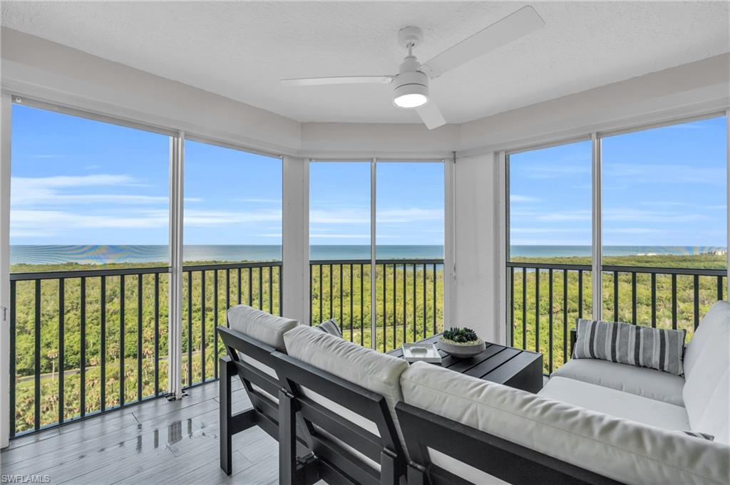 6573 Marissa Loop, Unit 1403 Naples, FL 34108 - Photo 24 of 29 a bedroom with furniture and large windows