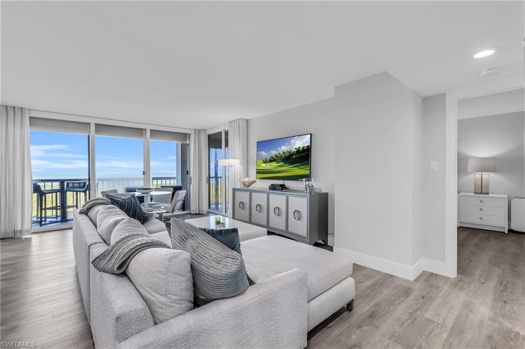 6573 Marissa Loop, Unit 1403 Naples, FL 34108 - Photo 3 of 29 a living room with furniture and a flat screen tv