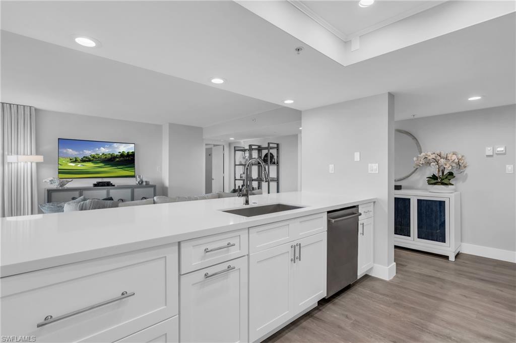 6573 Marissa Loop, Unit 1403 Naples, FL 34108 - Photo 7 of 29 a kitchen with a sink and cabinets