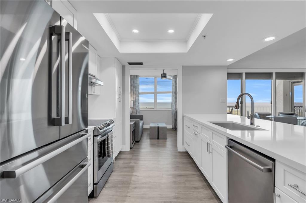 6573 Marissa Loop, Unit 1403 Naples, FL 34108 - Photo 8 of 29 a kitchen with stainless steel appliances a sink and a refrigerator