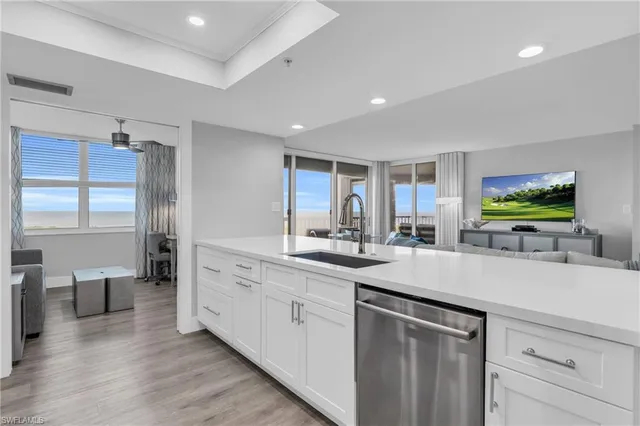 a kitchen with sink and white cabinets