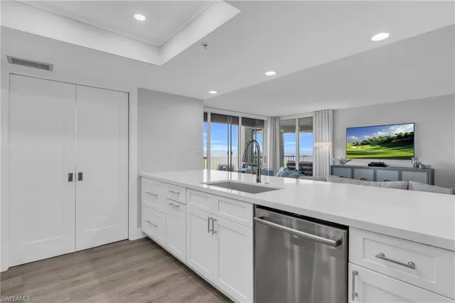 a kitchen with sink and view living room