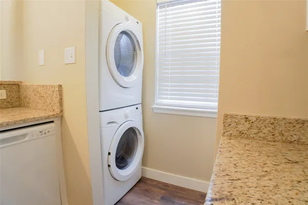 a bathroom with a granite countertop sink and white cabinets