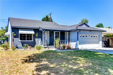 a front view of a house with outdoor seating