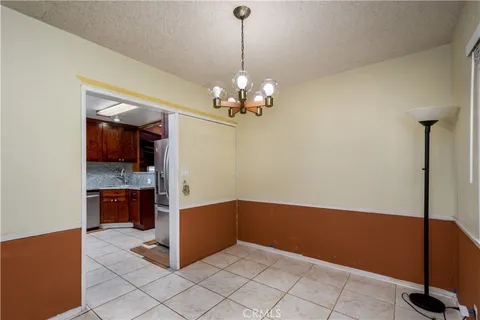 a kitchen with stainless steel appliances granite countertop a stove a sink dishwasher and a refrigerator