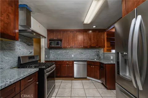 a kitchen with a sink a counter space and cabinets