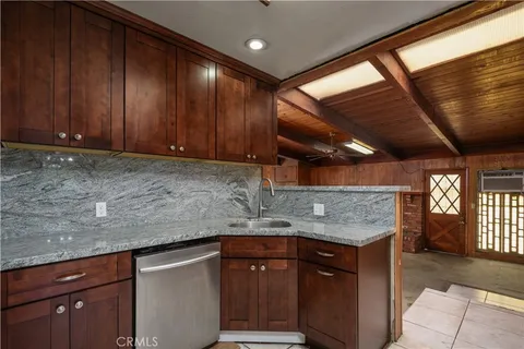 a view of an empty room with a fireplace and a window