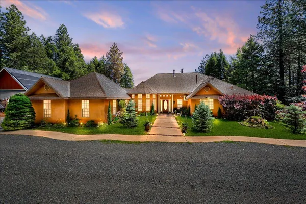 a front view of house with yard and green space