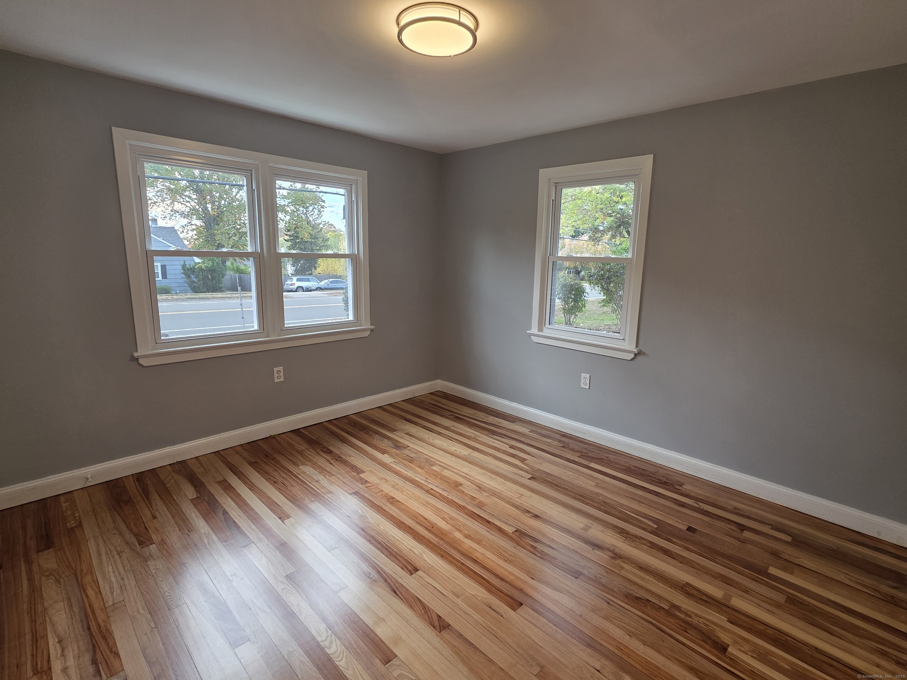62 Pond Point Avenue Milford, CT 06460 - Photo 12 of 15 a view of an empty room with wooden floor and a window