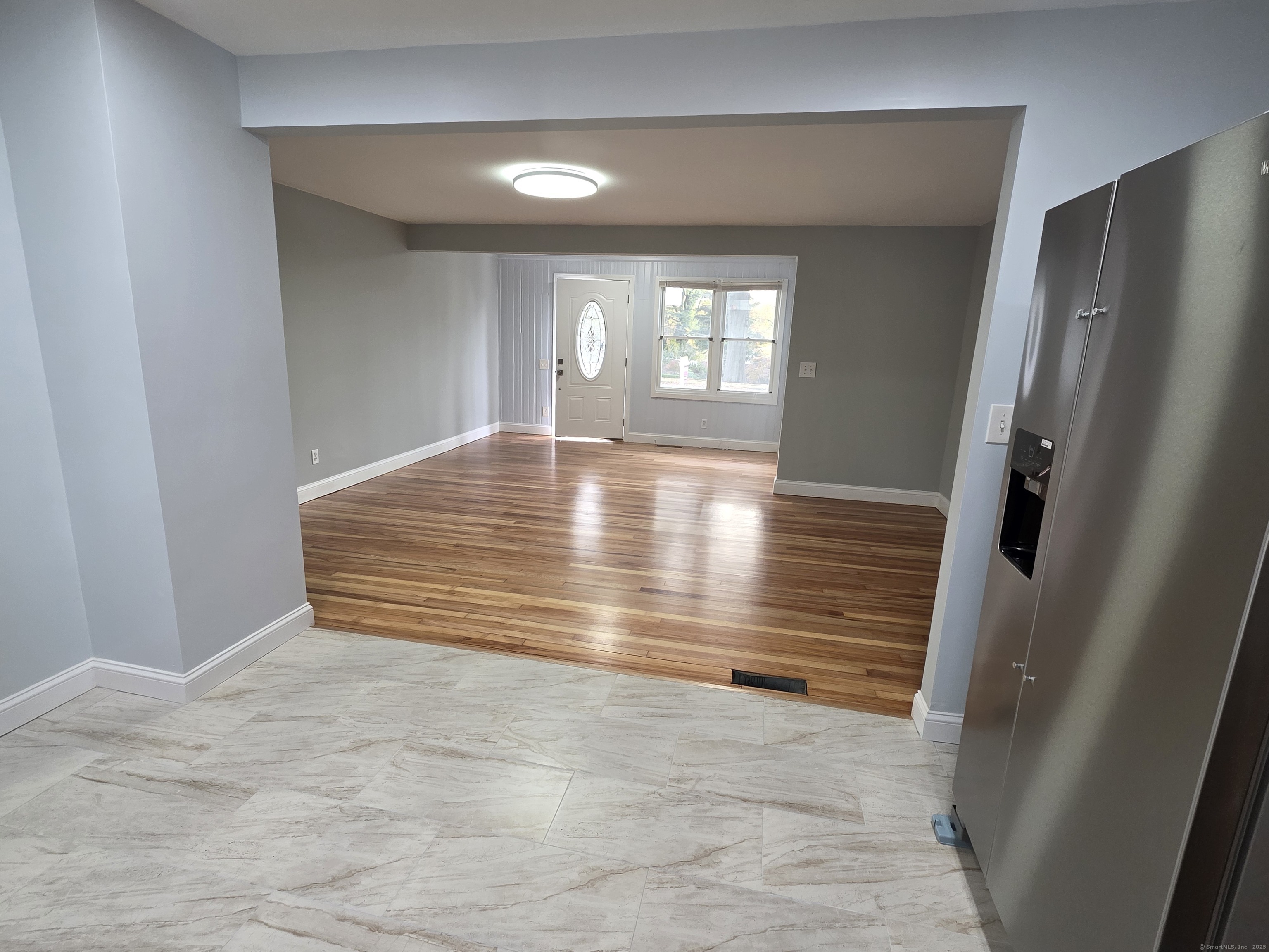 62 Pond Point Avenue Milford, CT 06460 - Photo 13 of 15 a view of an empty room with wooden floor and a window