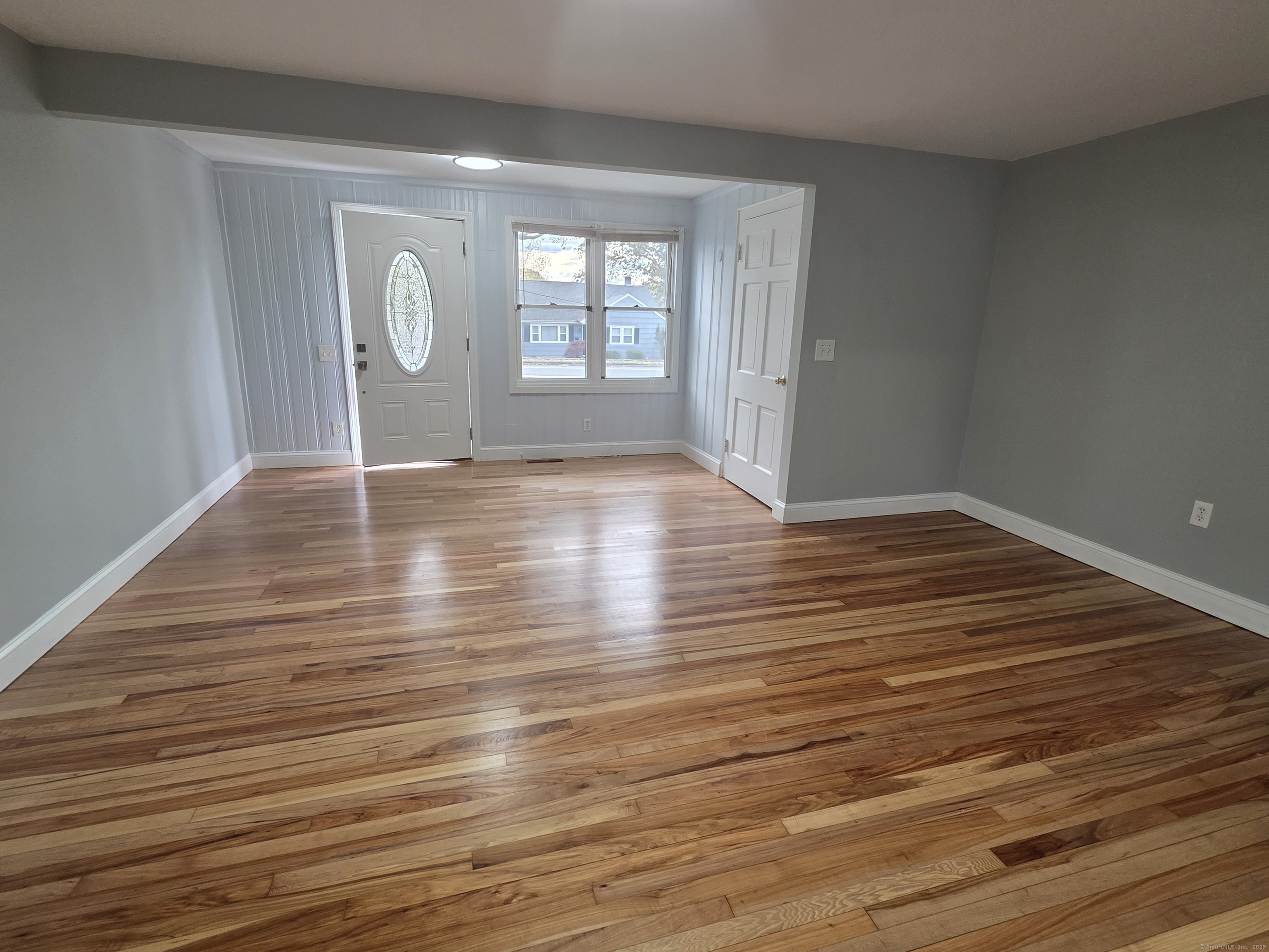 62 Pond Point Avenue Milford, CT 06460 - Photo 4 of 15 wooden floor in an empty room with a window