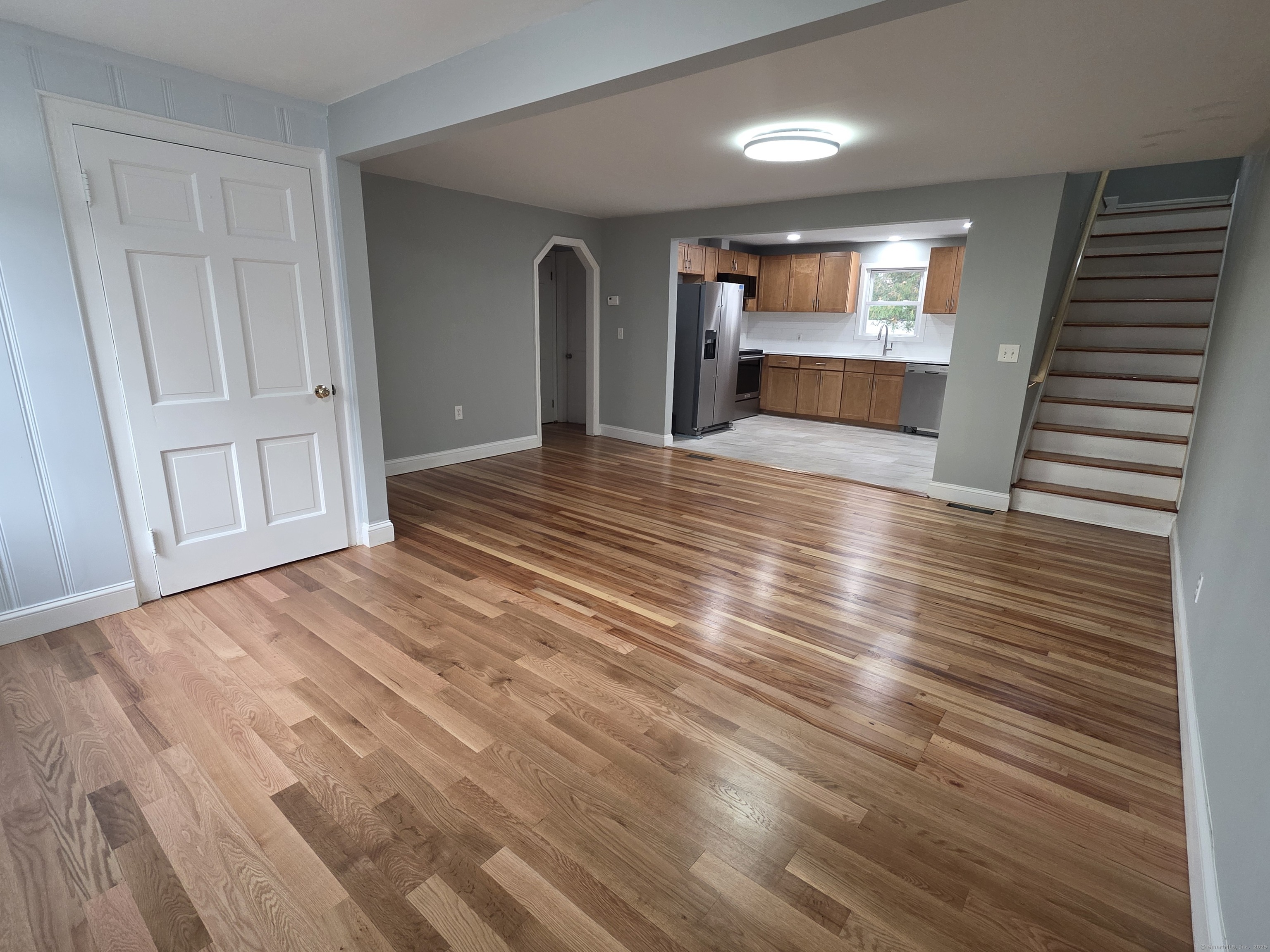 62 Pond Point Avenue Milford, CT 06460 - Photo 5 of 15 a view of empty room with wooden floor and fireplace