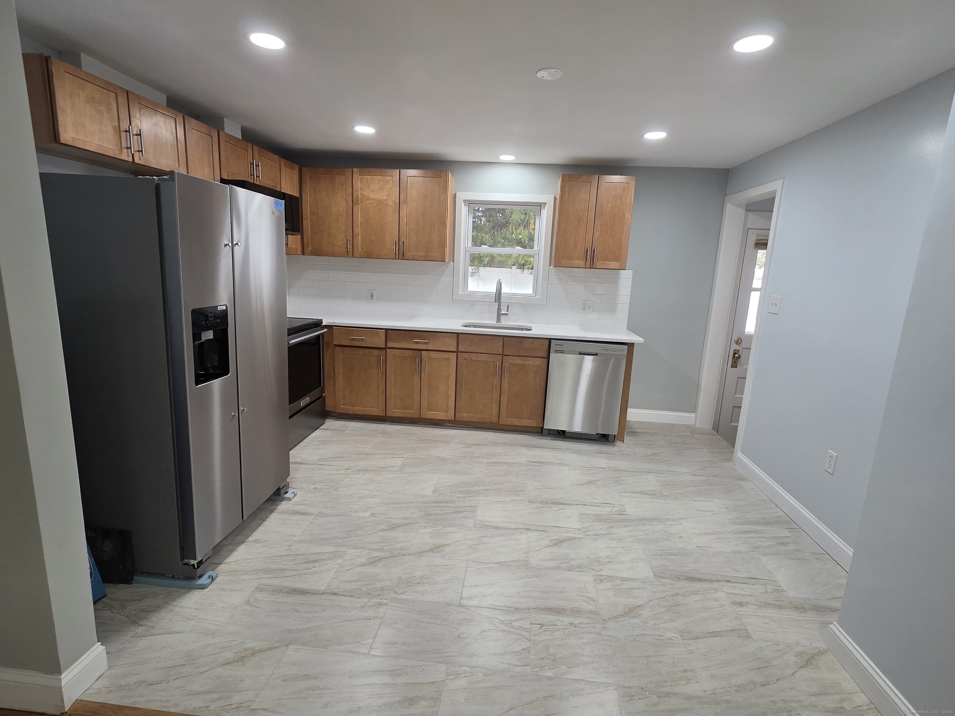 62 Pond Point Avenue Milford, CT 06460 - Photo 7 of 15 a kitchen with stainless steel appliances granite countertop a refrigerator and a stove top oven