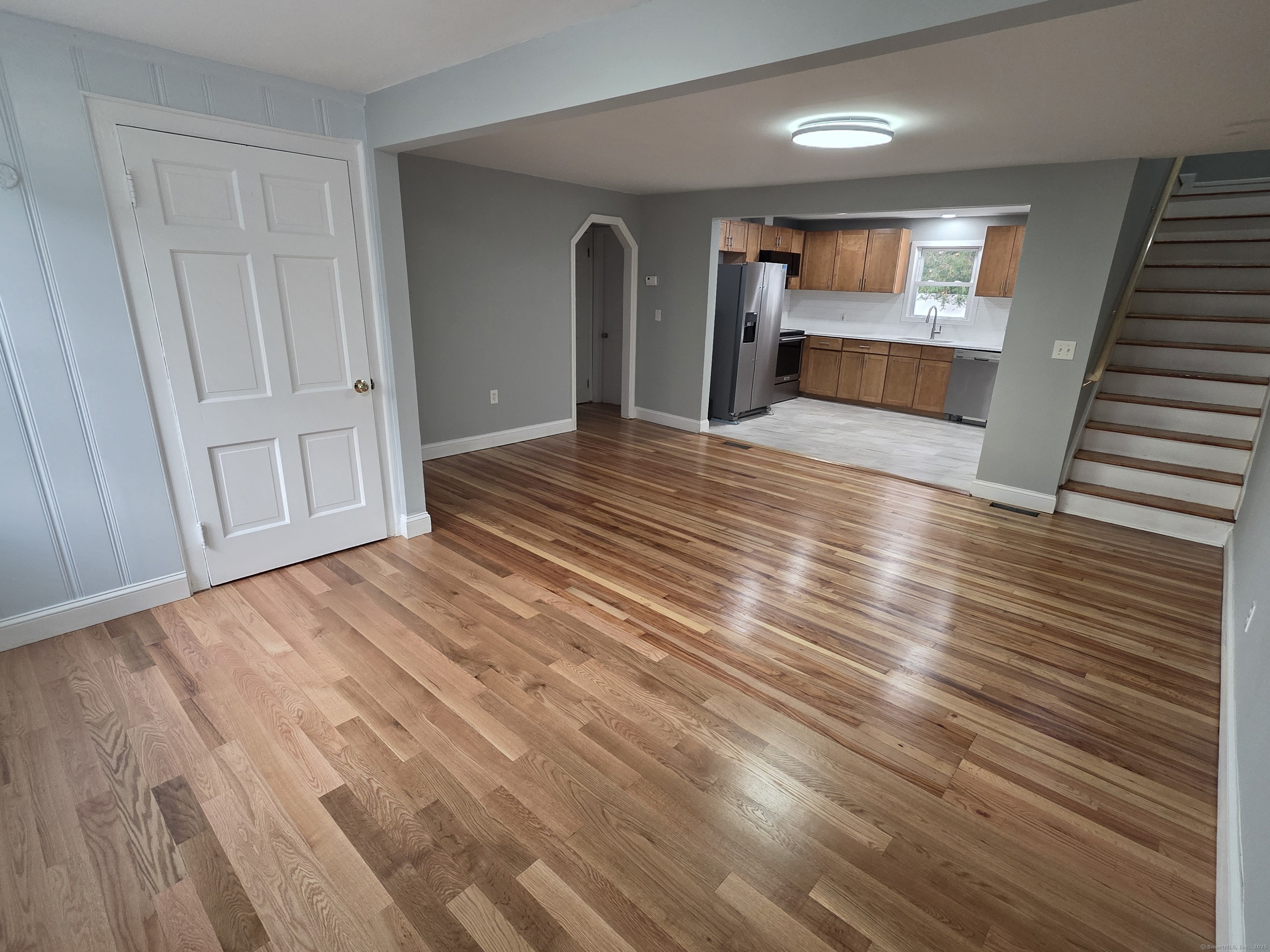 62 Pond Point Avenue Milford, CT 06460 - Photo 8 of 15 a view of empty room with wooden floor and fan