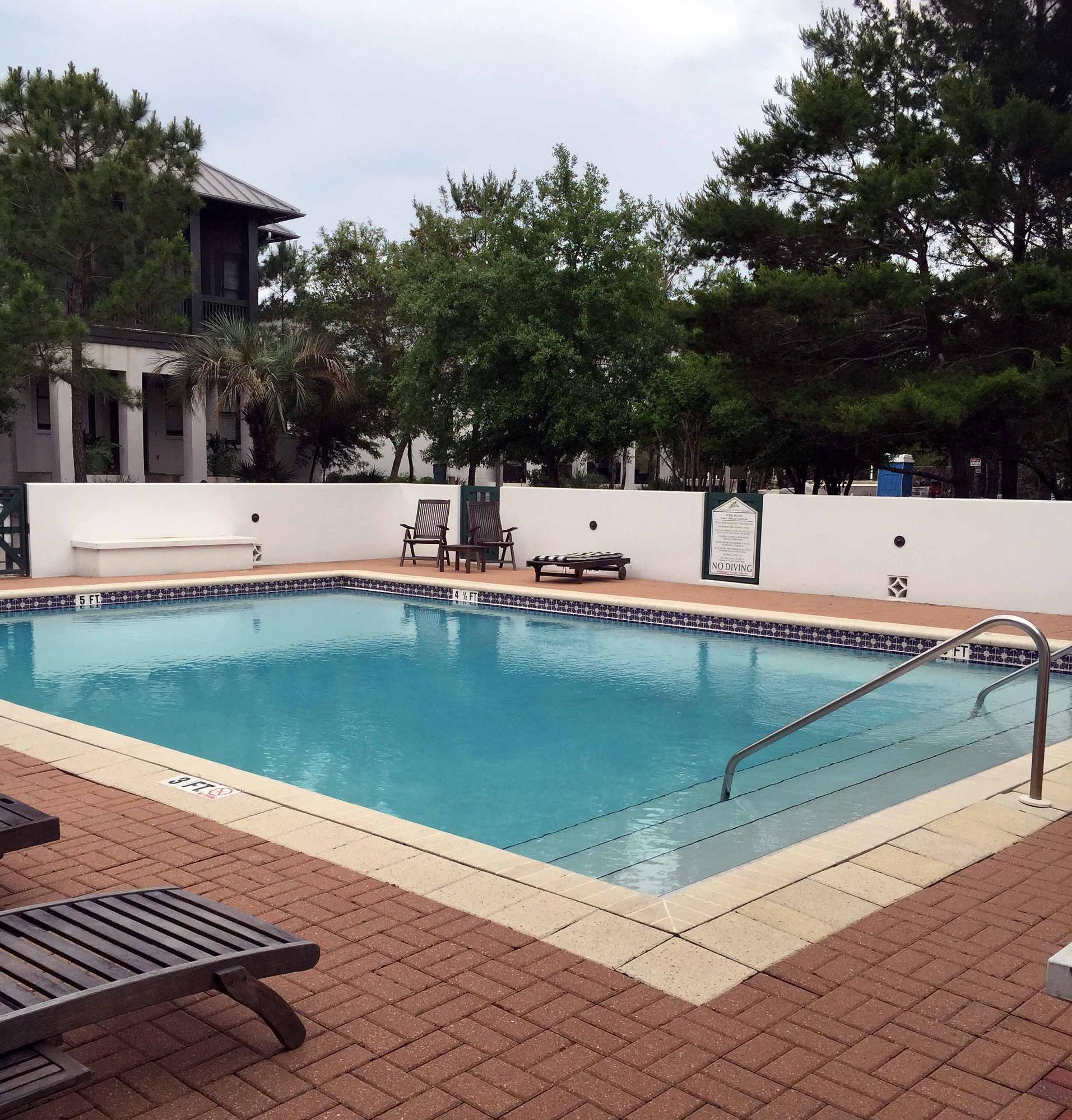 Lot 2 Pinecrest Inlet Beach Inlet Beach, FL 32461 - Photo 3 of 13 a view of a swimming pool with a lawn chairs under an umbrella