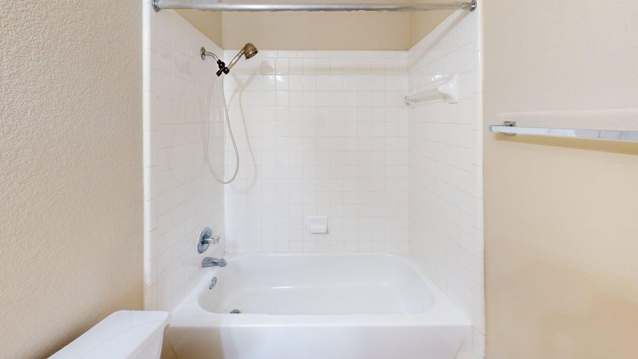 1716 Rosenborough Lane South Round Rock, TX 78665 - Photo 12 of 26 a bathroom with a bathtub and a shower
