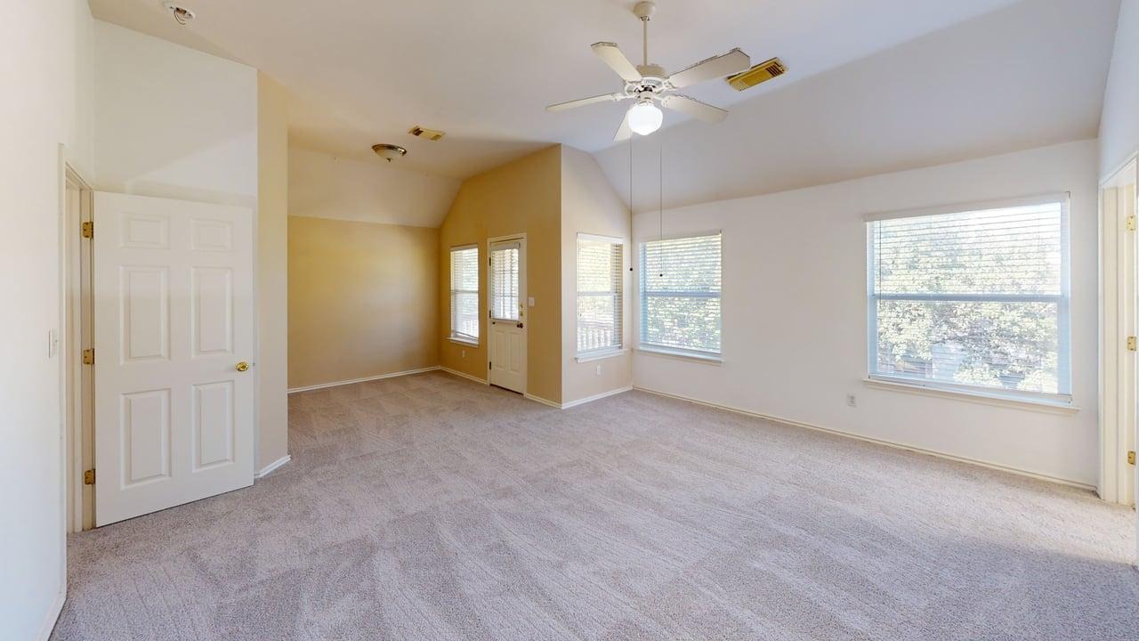 1716 Rosenborough Lane South Round Rock, TX 78665 - Photo 15 of 26 an empty room with windows and fan