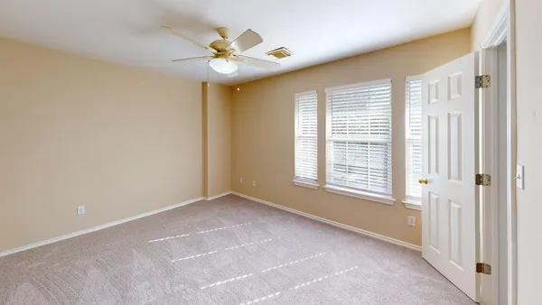 a view of an empty room and closet area