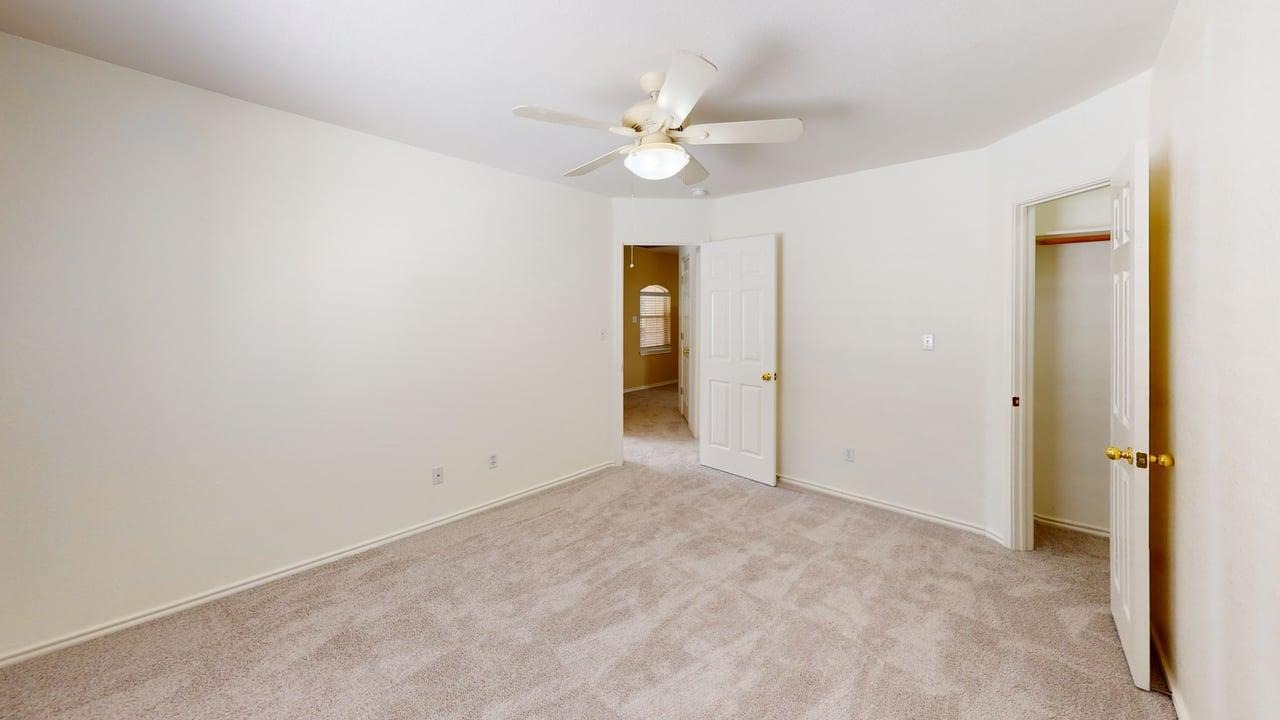 1716 Rosenborough Lane South Round Rock, TX 78665 - Photo 21 of 26 a view of an empty room with a chandelier fan