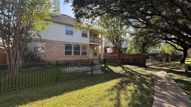 a backyard of a house with barbeque oven