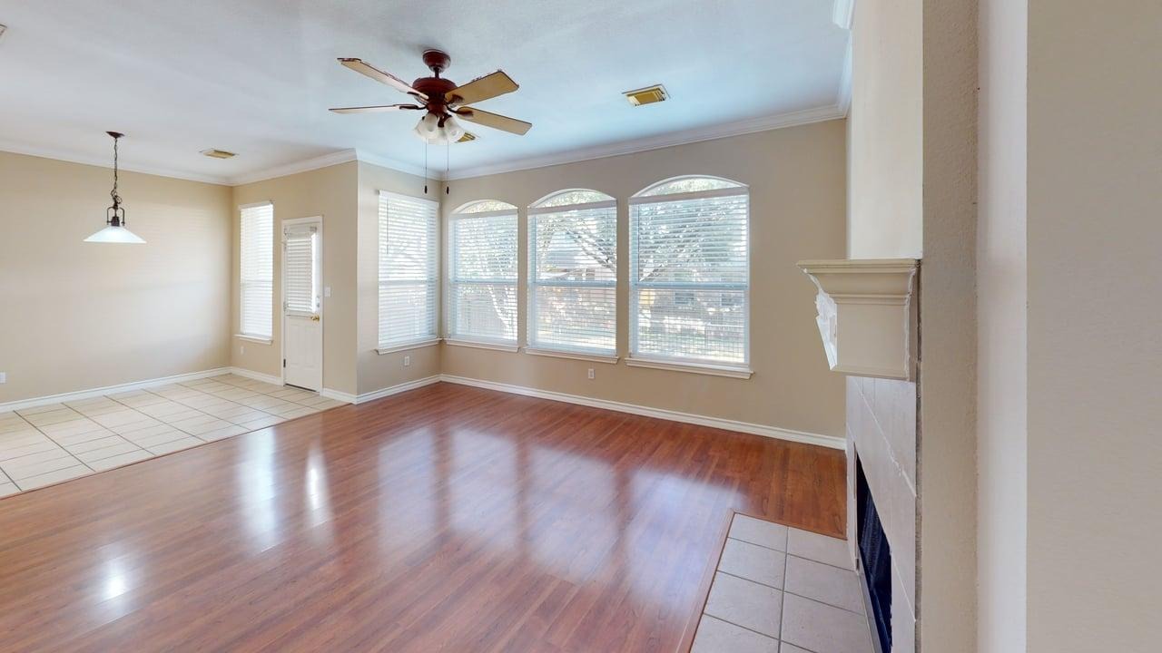 1716 Rosenborough Lane South Round Rock, TX 78665 - Photo 3 of 26 a view of an empty room with a window and wooden floor