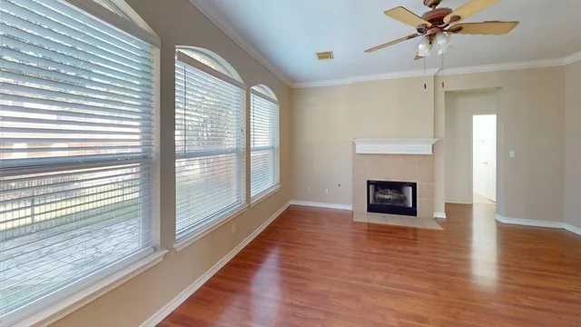 a view of a livingroom with a fireplace and window