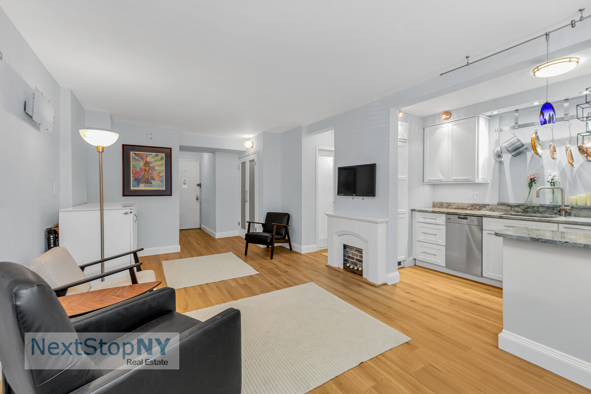 520 East 76th Street, Unit 1F Manhattan, NY 10021 - Photo 1 of 10 a bedroom with furniture and a flat screen tv