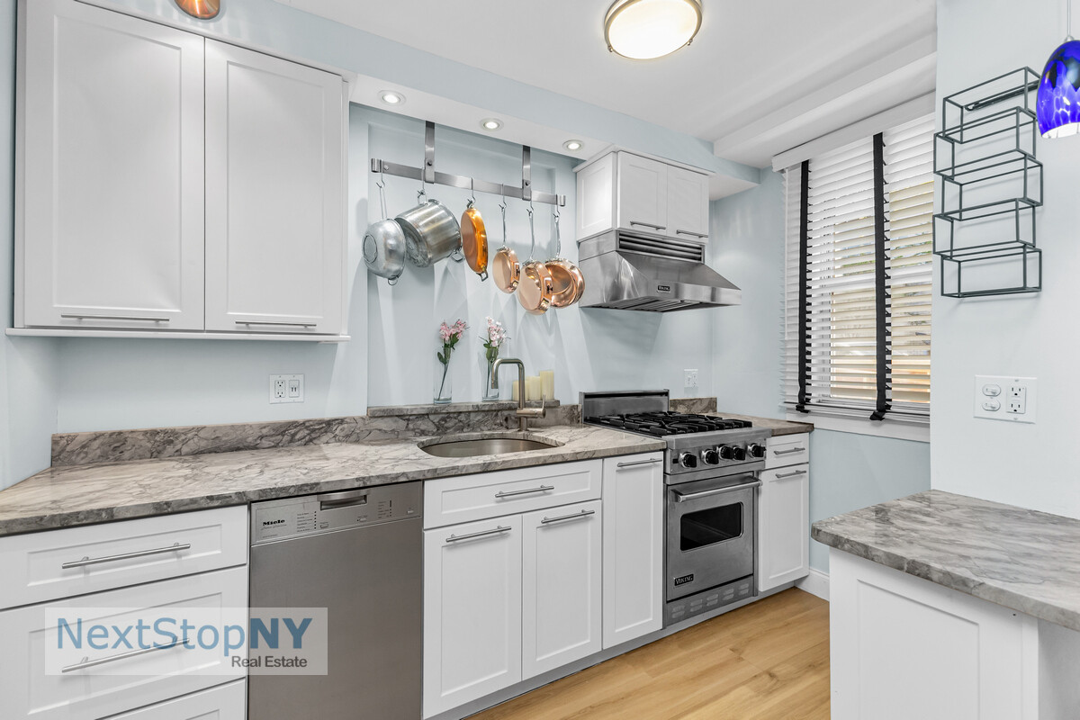 520 East 76th Street, Unit 1F Manhattan, NY 10021 - Photo 5 of 10 a kitchen with stainless steel appliances granite countertop a stove and a sink