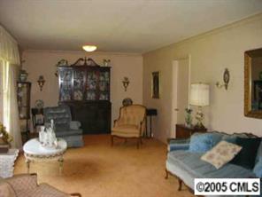 4200 Cheltenham Road Charlotte, NC 28211 - Photo 2 of 8 a living room with furniture and a chandelier
