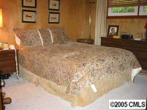 4200 Cheltenham Road Charlotte, NC 28211 - Photo 5 of 8 a bedroom with a bed and a night stand