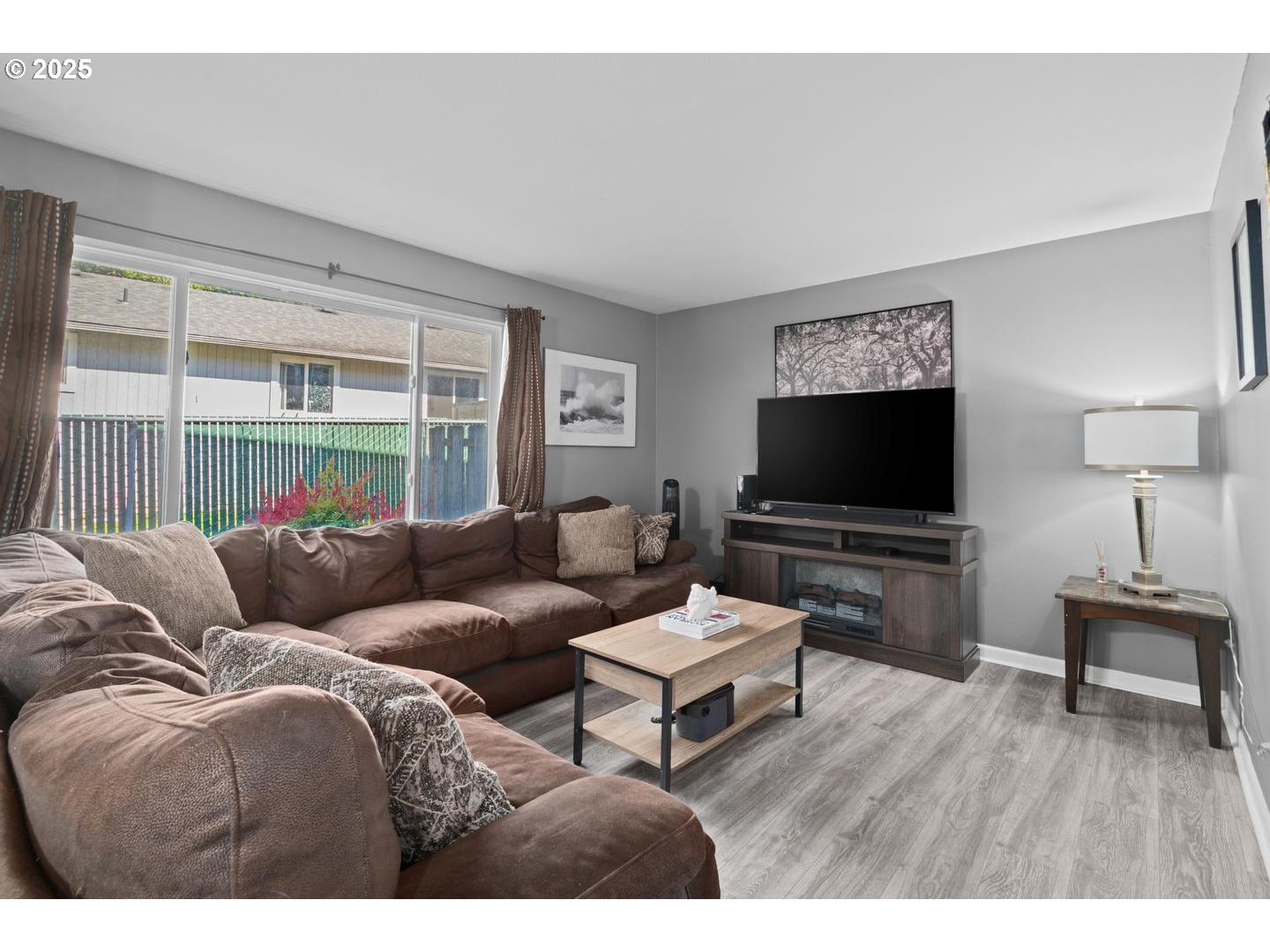 7143 Southwest Sagert Street, Unit 104 Tualatin, OR 97062 - Photo 13 of 33 a living room with furniture and a flat screen tv