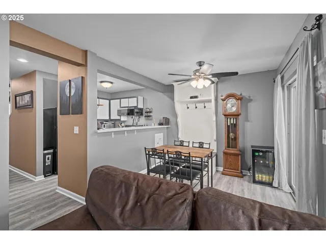 a living room with kitchen island granite countertop furniture and a wooden floor