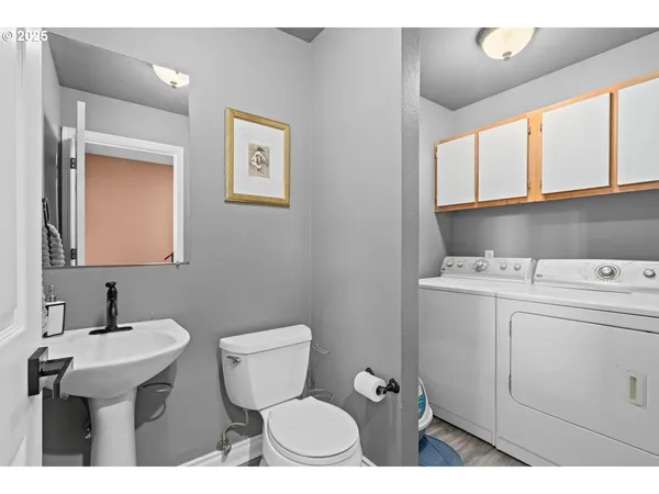 a bathroom with a sink toilet and mirror