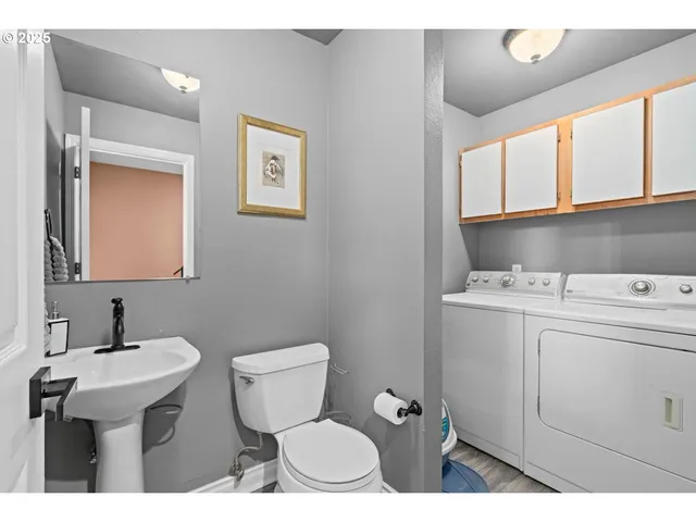 a bathroom with a sink toilet and mirror