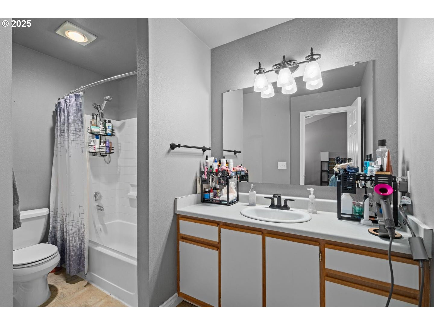 7143 Southwest Sagert Street, Unit 104 Tualatin, OR 97062 - Photo 21 of 33 a bathroom with a sink vanity and a mirror