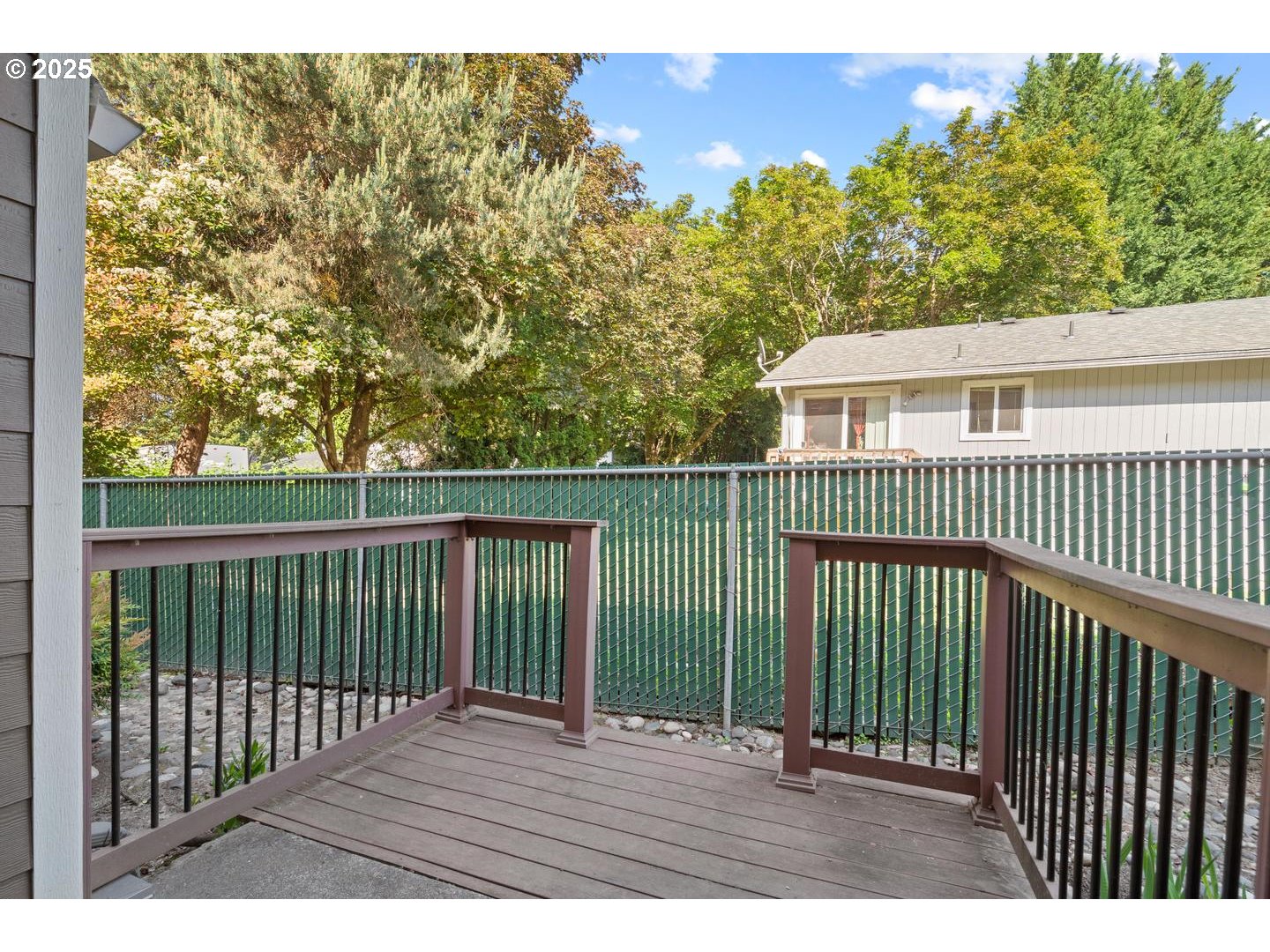 7143 Southwest Sagert Street, Unit 104 Tualatin, OR 97062 - Photo 25 of 33 a view of backyard with a deck and wooden fence