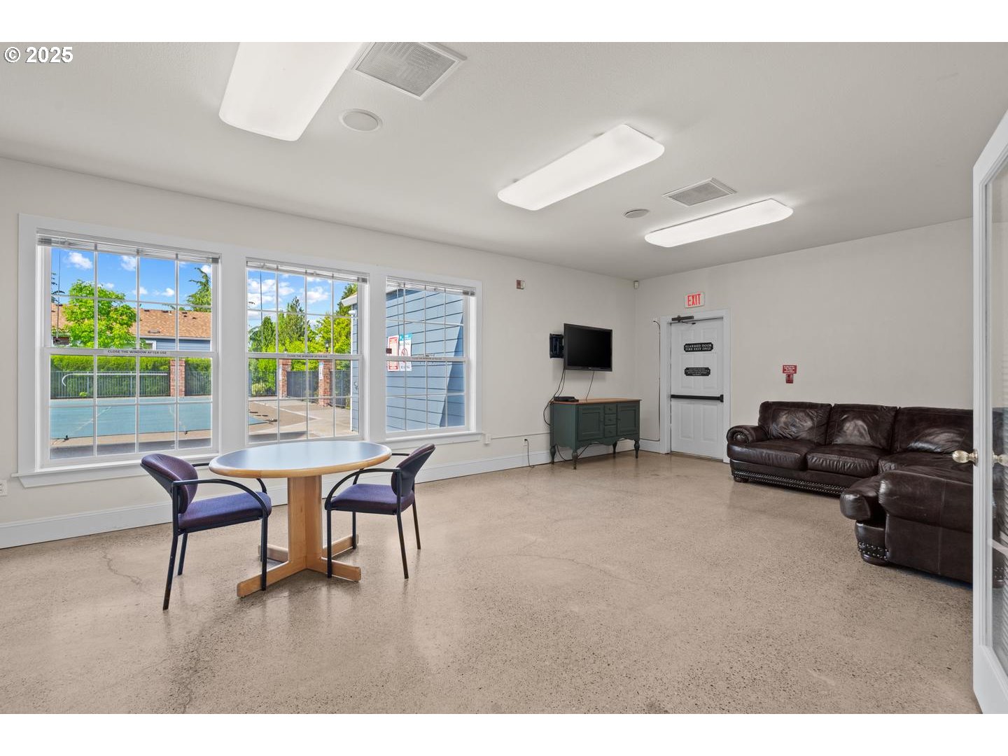7143 Southwest Sagert Street, Unit 104 Tualatin, OR 97062 - Photo 29 of 33 a living room with furniture and a wooden floor