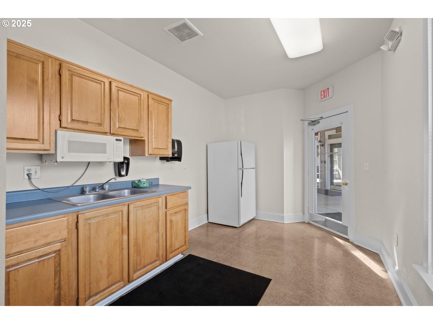 7143 Southwest Sagert Street, Unit 104 Tualatin, OR 97062 - Photo 30 of 33 a kitchen with stainless steel appliances granite countertop a sink and cabinets