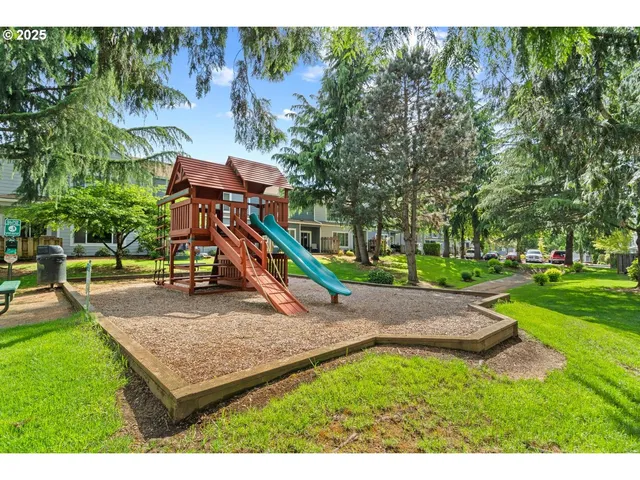 an aerial view of a city with lots of residential buildings ocean and mountain view in back