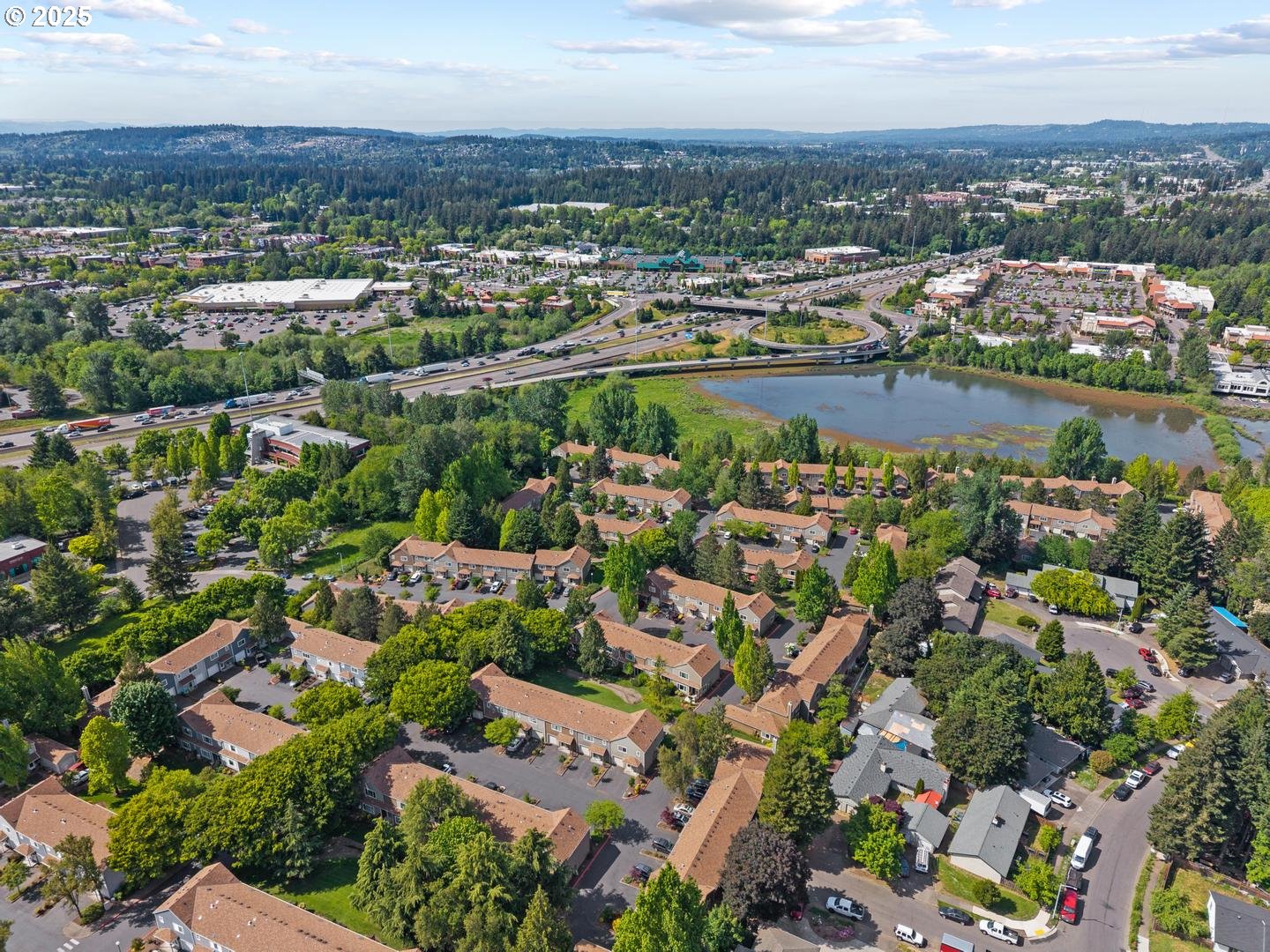 7143 Southwest Sagert Street, Unit 104 Tualatin, OR 97062 - Photo 33 of 33 an aerial view of a city with lots of residential buildings ocean and mountain view in back