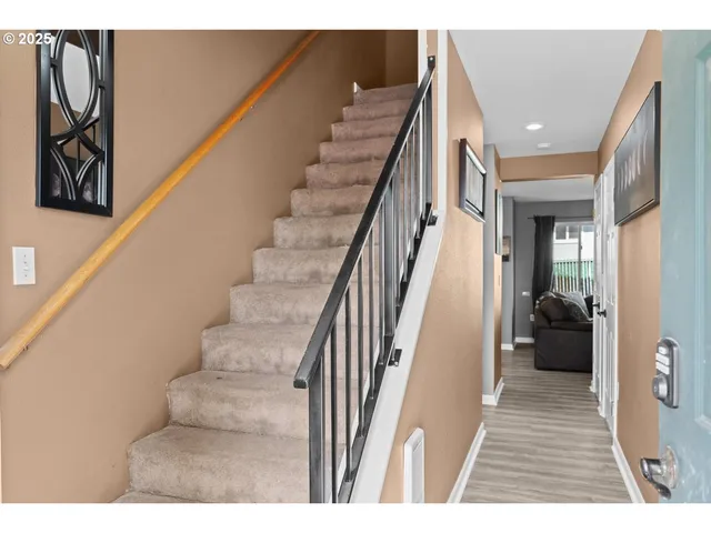a view of entryway and hall with wooden floor