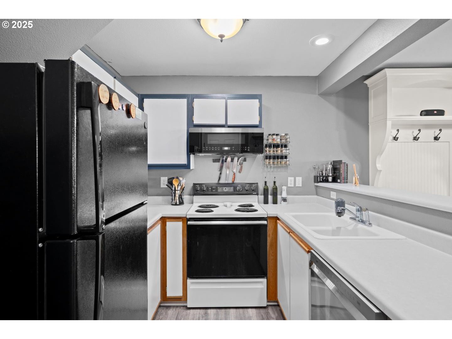 7143 Southwest Sagert Street, Unit 104 Tualatin, OR 97062 - Photo 5 of 33 a kitchen with stainless steel appliances granite countertop a sink stove and refrigerator