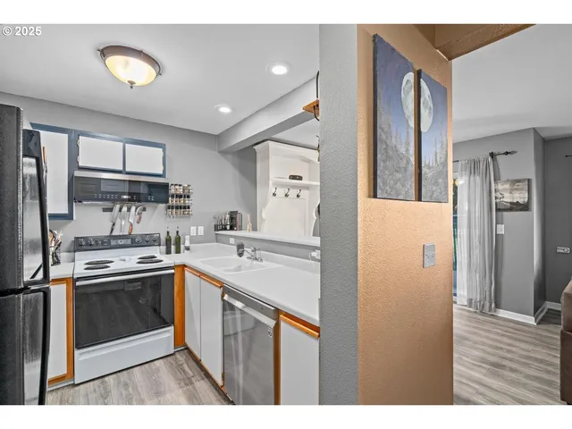 a kitchen with a sink stove and refrigerator