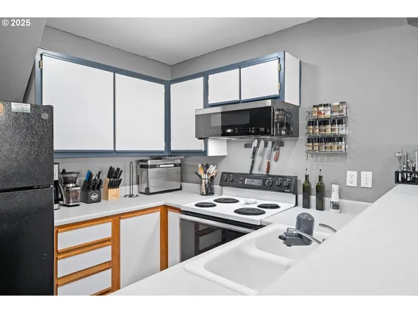 a kitchen with a sink a stove and a microwave